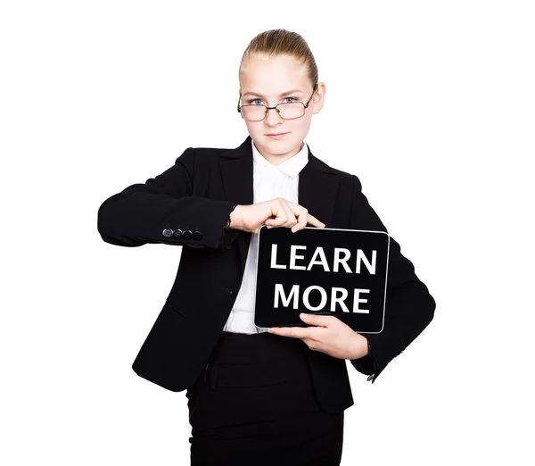 Schoolmeisje in een Business Suit houdt een PC Tablet in zijn handen met inscriptie meer informatie — Stockfoto