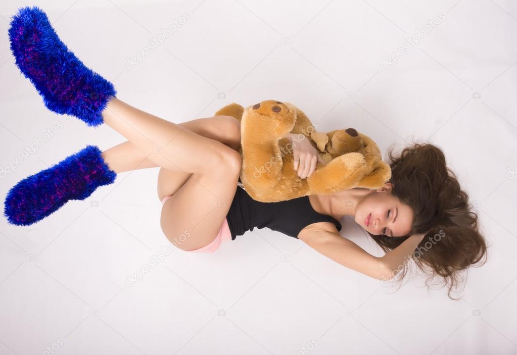 sexy young woman wearing pink shorts with a teddy bear