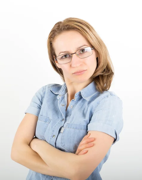 Beautiful young woman has many different emotions from happiness, sadness to anger and stress. She is wearing a denim shirt and glasses — Stock Photo, Image
