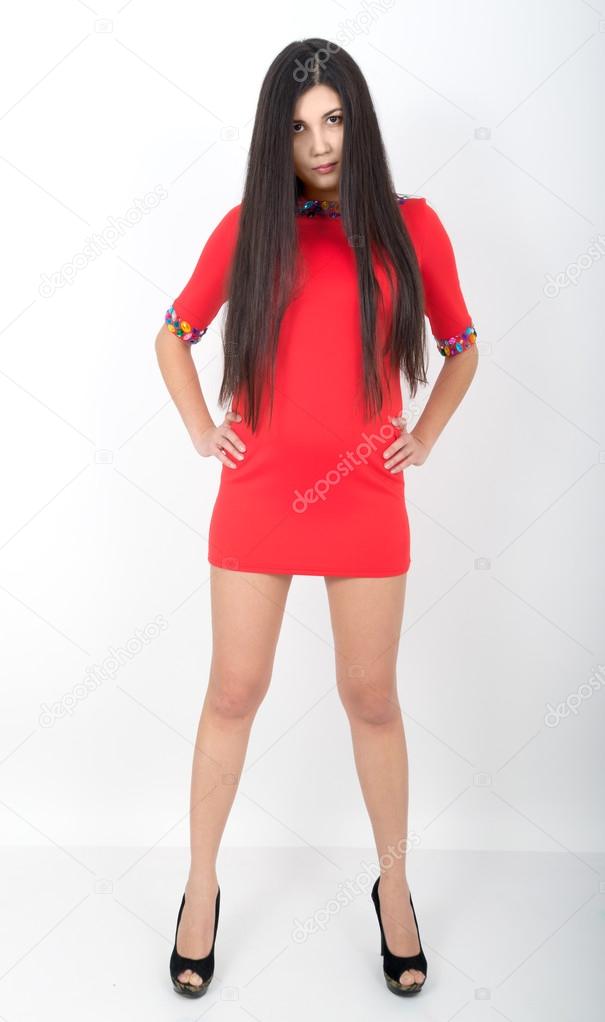 full height a young pretty slim asian woman standing in a little red dress