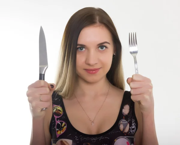 Yakın çekim ince kız bir mayo, bıçak ve çatal tutan bir kız içinde. kavram aç kız — Stok fotoğraf
