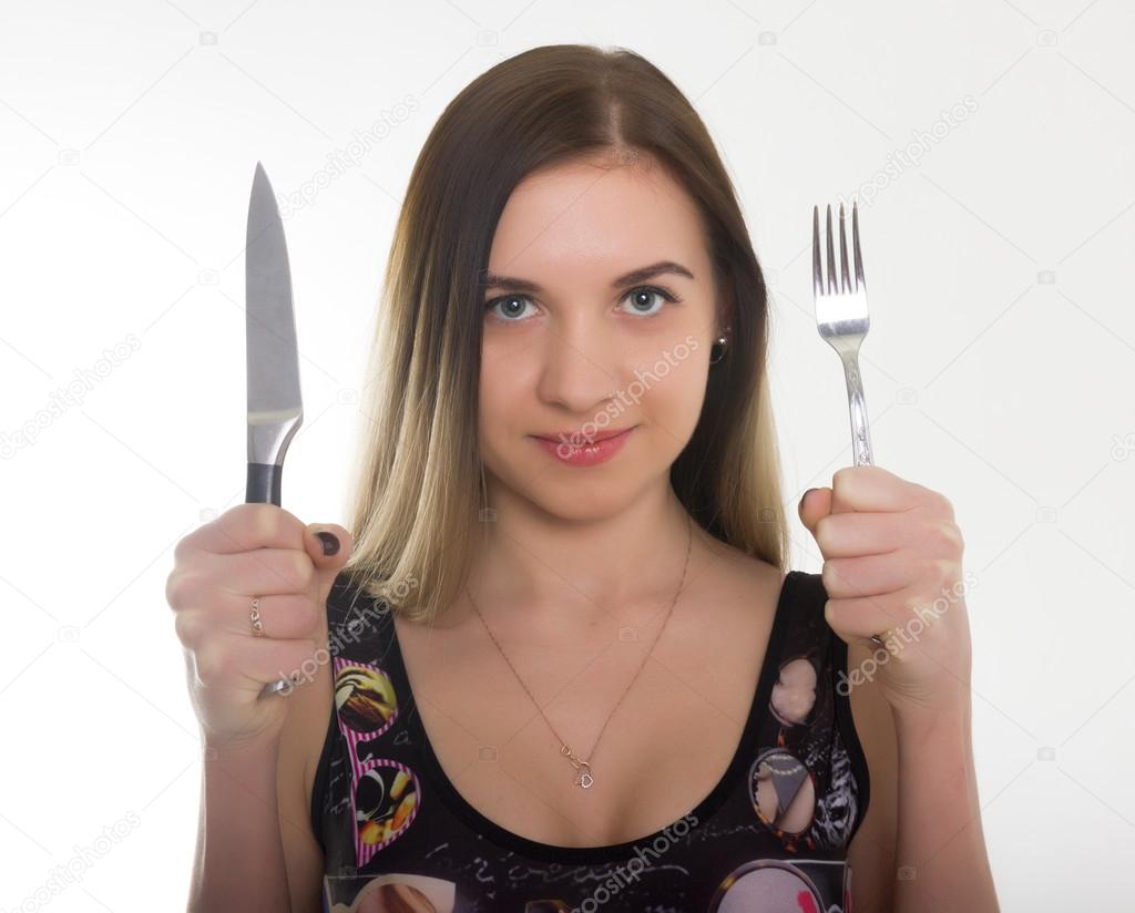 close-up slim girl in a bathing suit, a girl holding a knife and fork. concept hungry girl