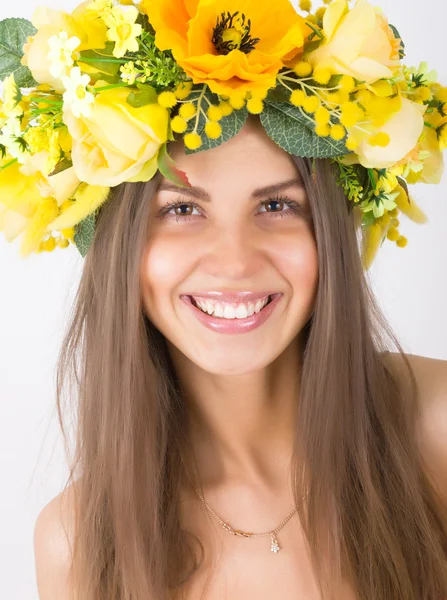 Portrait of beautiful girl with floral wreath on her head — Stock Photo, Image