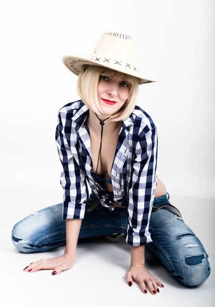 Young beautiful sexy woman in a plaid shirt jeans and a cowboy hat — 图库照片