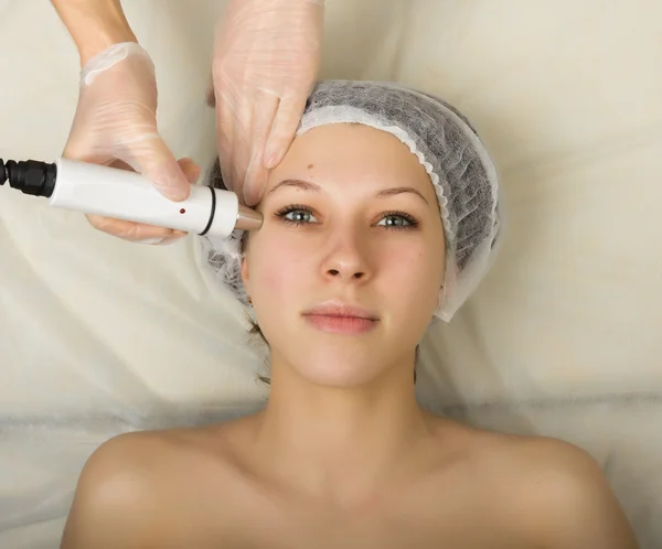 Beautician examining the face of a young female client at spa salon. getting rf-lifting in a beauty salon. Professional consultation — Stock Fotó