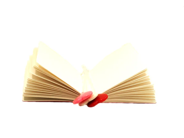 Red white and pink heart on the open book isolated on white background, select focus. — Stock Photo, Image