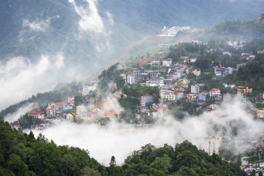 Sapa valley city in the mist in the evening, Vietnam clipart