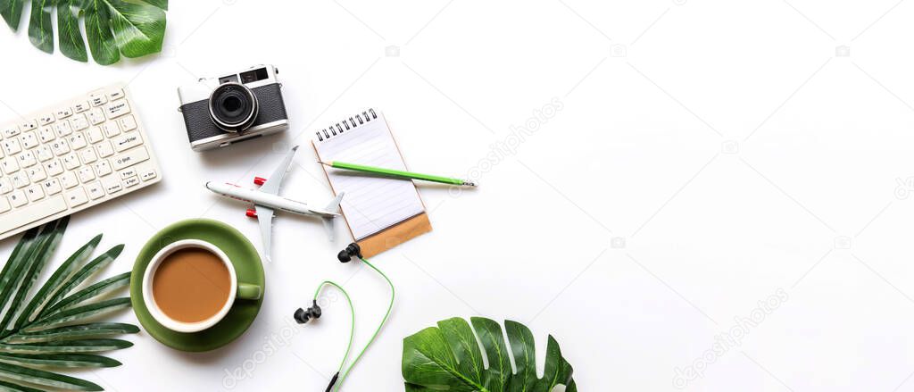 Traveler accessories and green cup coffee  with tourism backpack and visiting for planning trips travel destination and vacations,  leaf green and white background.  Top view and copy space for banner text.  Travel and Summer holiday concept 
