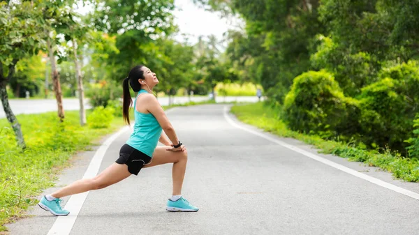 Healthy Smiling Woman Warming Stretching Her Legs Looking Away Road — Stock Photo, Image