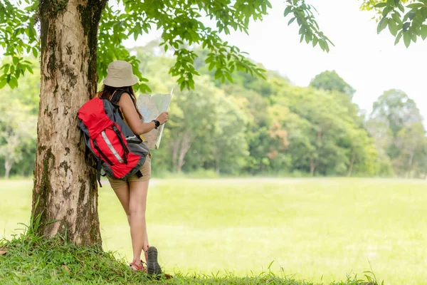 女徒步旅行者或背着背包旅行的人拿着地图在丛林森林里寻找方向和放松一下 以便外出度假时进行目的地休闲教育 旅行和生活方式概念 — 图库照片