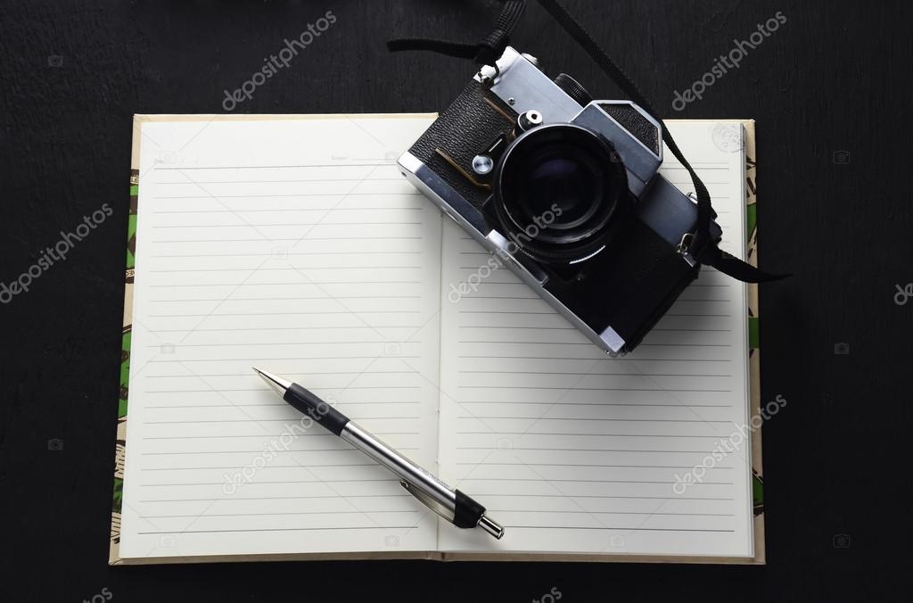 Vintage photo camera on the book