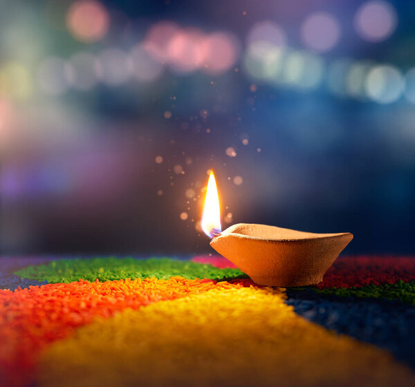 Happy Diwali, Lit diya lamp on an abtract background with shallow depth of field