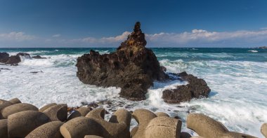 Foamy surf on rocky beach clipart