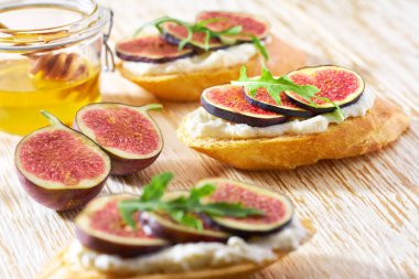 Ricotta peynirli bruschetta, taze incir, bal ve roka..