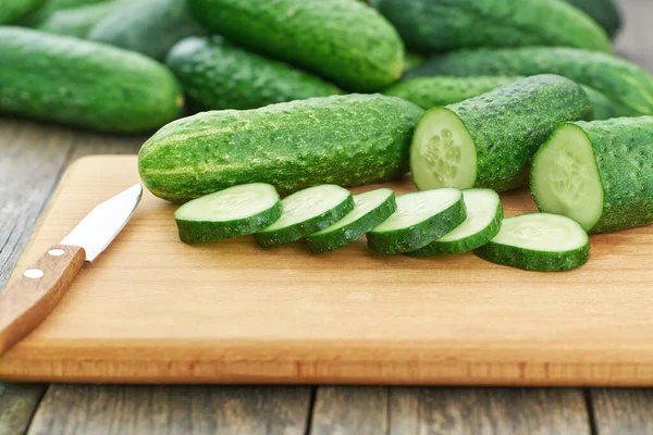 Whole Sliced Fresh Cucumbers Cutting Board Rustic Style — 图库照片