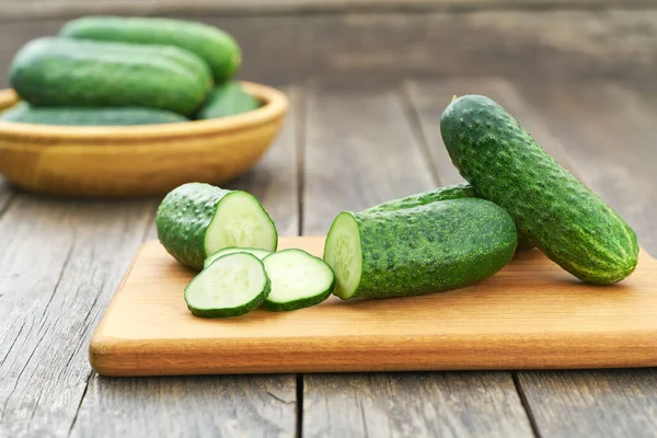 Whole Sliced Fresh Cucumbers Cutting Board Rustic Style — 图库照片