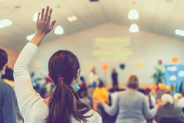 People praying in a church. soft focus of christian people group raise hands up worship God Jesus Christ together in church. toned.