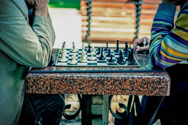 Satranç oynayan iki yaşlı adam. Aktif emekliler, eski dostlar ve boş zaman. Aktif emekliler, eski dostlar ve boş zaman. İki son sınıf öğrencisi parkta satranç oynuyor. Bulanık. ses tonlu