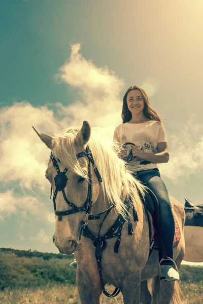 The rider on the white horse. Young horsewoman riding on white horse, outdoors view. girl on white horse runs free. toned — Stock Photo, Image