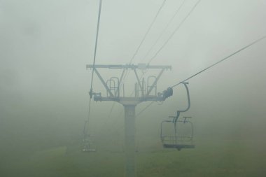 Yaz sisli sabahı, sessizlik ve Baykal Gölü kıyısındaki Listvyanka 'da bir teleferik.