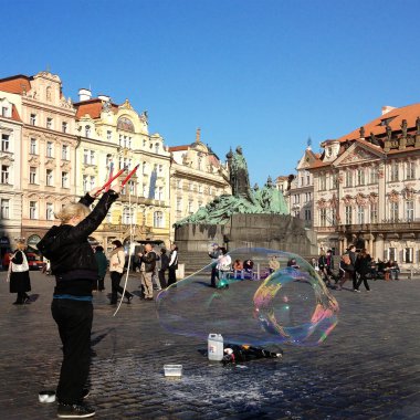 Unidentified woman makes soap bubbles in Old Town Square in Prague, Czech Republic clipart
