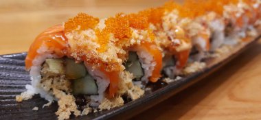 Salmon Crispy Sushi Roll with Orange Tobiko Served on a Plate. Presentation Japanese Food Photography