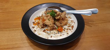 Creamy Cheesey Sauce Udon Carbonara with Fried Chicken Served on a Plate on a Wooden Table. Japanese Food Style Photography Presentation