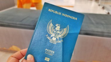 Bekasi, West Java, Indonesia - December 24 2025. Indonesian Passport Held in Hand, Ready for Travel