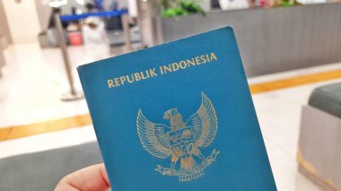 Bekasi, West Java, Indonesia - December 24 2025. Indonesian Passport Held in Hand, Ready for Travel