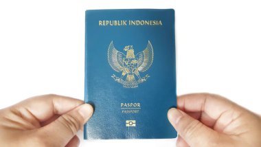 Bekasi, West Java, Indonesia - December 24 2025. Hand holding an Indonesian passport