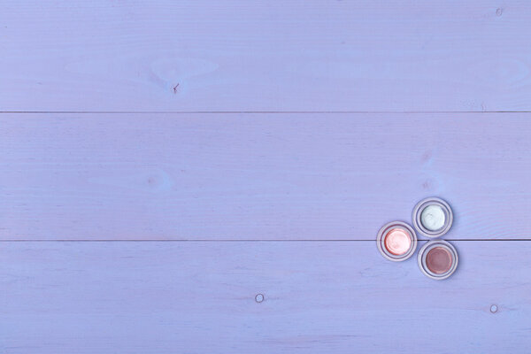 Cosmetics. Three colorful eyeshadows