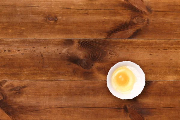 Egg and flour on a wooden table — Stock Photo, Image