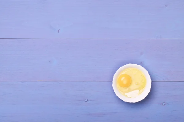 Egg and flour on a wooden table — Stock Photo, Image