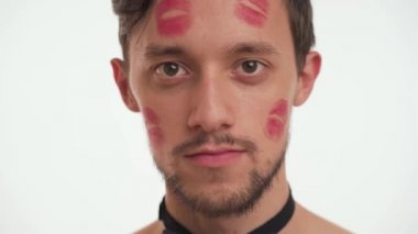 One sexy Caucasian Casanova man with brown eyes, short hair, beard, moustache look at camera, blowing kiss isolated on white background close-up indoors. Romantic concept of Happy Valentines day.