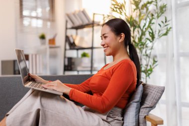 young woman using laptop computer at home office