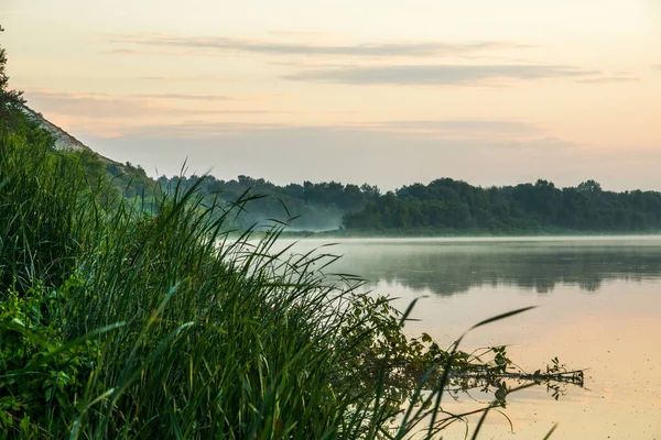 Pre-dawn river Don near the village of Kazan, Rostov region of Russia. Light fog spreads over mirror-smooth water