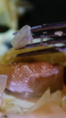 Çatal kırmak armut gevrek puf hamur tatlısı ve kremalı şurup ile siyah tabakta kadın eliyle zarif bir tatlı restoranı sunumunu kapat.