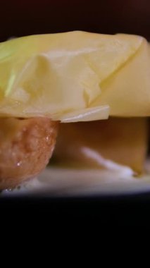 Karamelli armudu çıtır börek ve siyah tabakta kremalı şurupla kapat. Çatalla kırılan kadın eliyle enfes bir tatlı restoranı videosu..