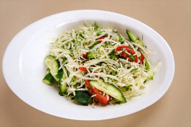 Vegetarian salad. Spring vegan salad with cabbage, cucumber, green onion and parsley. Top view, flat lay, overhead. High quality photo