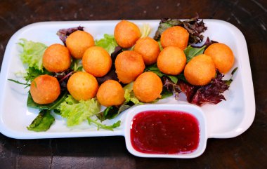 Cheese Balls with dip, crane sauce onion, carrot and lettuce leaf served in dish isolated on wooden table side view of arabic food. High quality photo
