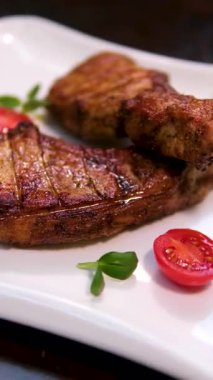 İki tabakta peynir, mantar ve taze domatesle servis edilen ızgara et. Lezzetli şehir yemekleri canlı renkler ve dokular yakalıyor. Yüksek kalite 4k görüntü