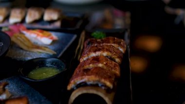 Suşi Sashimi Nigiri Tabağı, Japon gunkan maki suşi restoranı, Taze Ton Balığı ve Somon Dilimleri modern kafede, geleneksel yemekler, çiğ kırmızı balık tabağı, omega 3. Suşi yılan balığı yemeği.