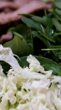 Kırmızı tabakta domuz eti, roka ve Çin lahanası. Çin böreği ve Asya mutfağı salatası yapmak için gerekli malzemeler. Yüksek kalite 4k görüntü