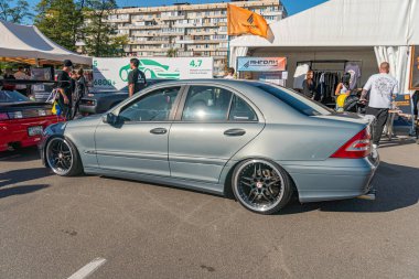 Canlı bir araba şovu sahnesi, siyah jantlı gümüş gri bir hatchback 'in etrafında çeşitli renk ve boyutlarda diğer araçların yer aldığı arka plan Kyiv, Ukrayna - 21 Eylül 2025