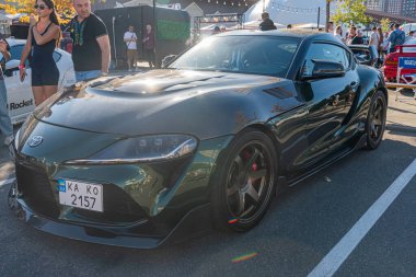 Özel yapım koyu renk spor bir arabanın yakın çekimi, muhtemelen bir Toyota Supra, kaputu delik, geniş gövdeli, ve çok dilli tekerlekleri olan araba düşük sürüşlü, ayırt edici desi Kyiv, Ukrayna - 21 Eylül 2025