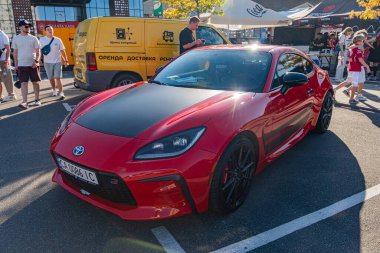 Siyah aksanlı kırmızı Toyota Supra, parlak tasarım, aerodinamik eğriler, büyük hava girişleri, arka spoiler, alaşımlı tekerlekler, çok dilli tasarım, yan açı Kyiv, Ukrayna - 21 Eylül 2025