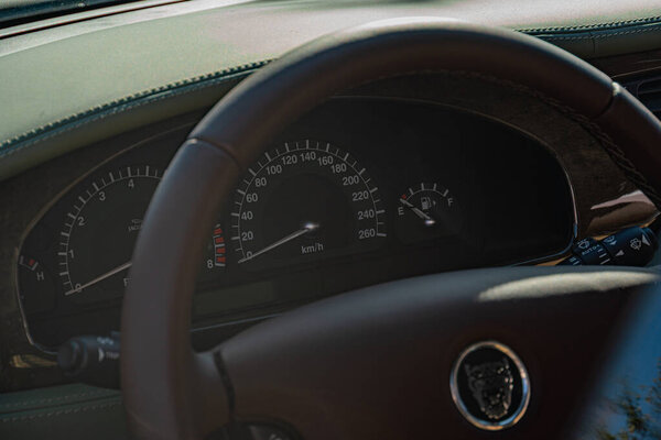 Close-up view of a Jaguar steering wheel and dashboard, taken from the drivers seat Leather perforated steering wheel with logo, encased in sporty binnacle Functi Kyiv, Ukraine - September 21, 2025