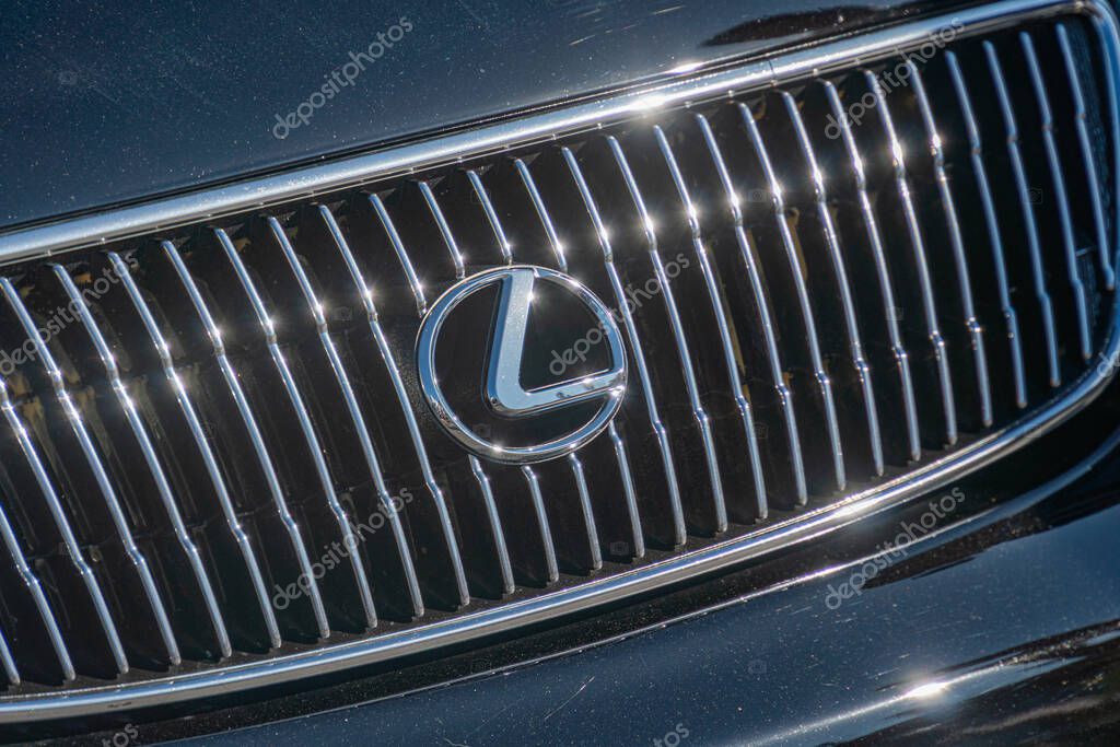 Close-up view of a Lexus car, angled from above, with a dark colored grille featuring a complex pattern and LED elements, prominently displaying the brand logo Kyiv, Ukraine - September 21, 2025