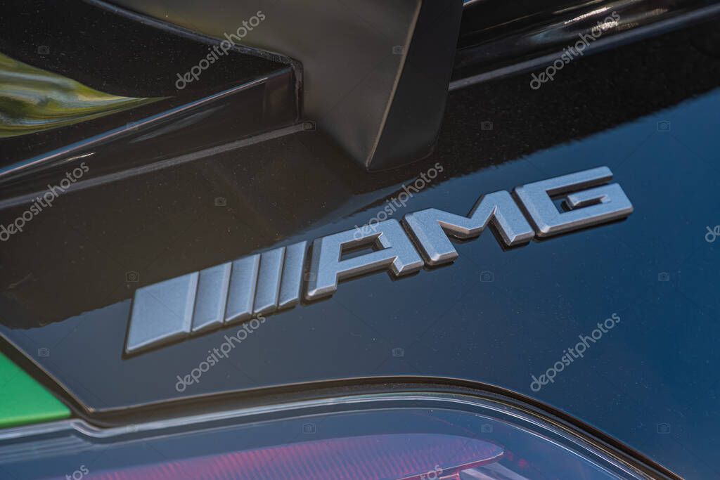Blurred outdoor setting with a close-up of a moving Mercedes AMG car, featuring dark metallic bodywork and chrome accents Kyiv, Ukraine - September 21, 2025