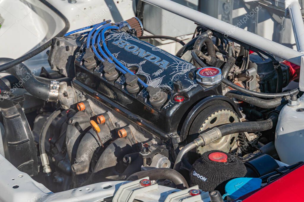 Close-up view of an open Honda car engine in a controlled environment, with muted shades of gray, silver, and blue The engine is metallic, detailed, and has the Hon Kyiv, Ukraine - September 21, 2025